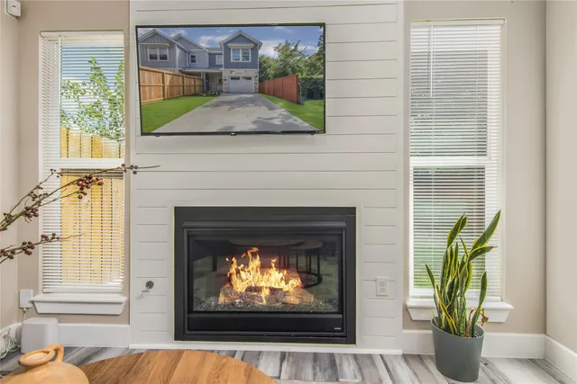 a living room with furniture kitchen view and a chandelier