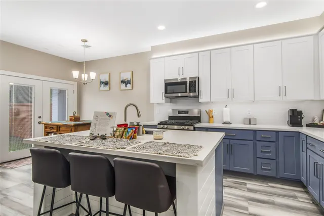 a kitchen with white cabinets and a sink