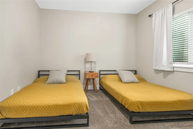 a bedroom with bed and balcony