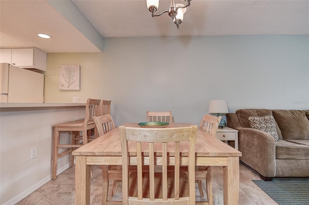 12900 Vonn Road, Unit C202 Largo, FL 33774 - Photo 11 of 38 a bedroom with a bed and a chandelier