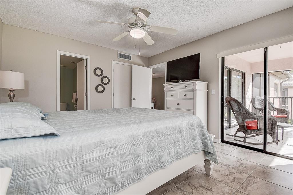 12900 Vonn Road, Unit C202 Largo, FL 33774 - Photo 20 of 38 a bedroom with a large bed and a flat screen tv
