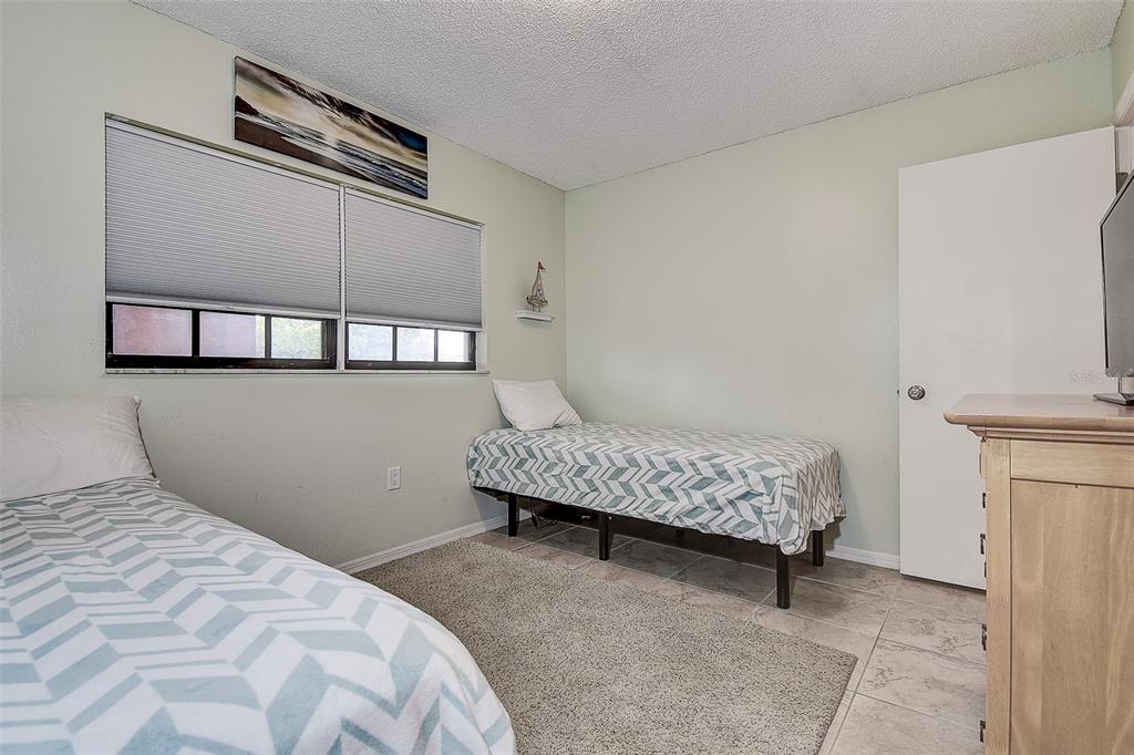 12900 Vonn Road, Unit C202 Largo, FL 33774 - Photo 24 of 38 a bedroom with a bed and a window