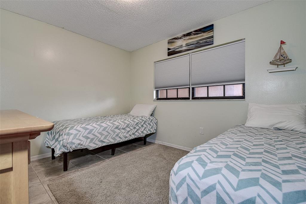 12900 Vonn Road, Unit C202 Largo, FL 33774 - Photo 25 of 38 a bedroom with a bed and a window