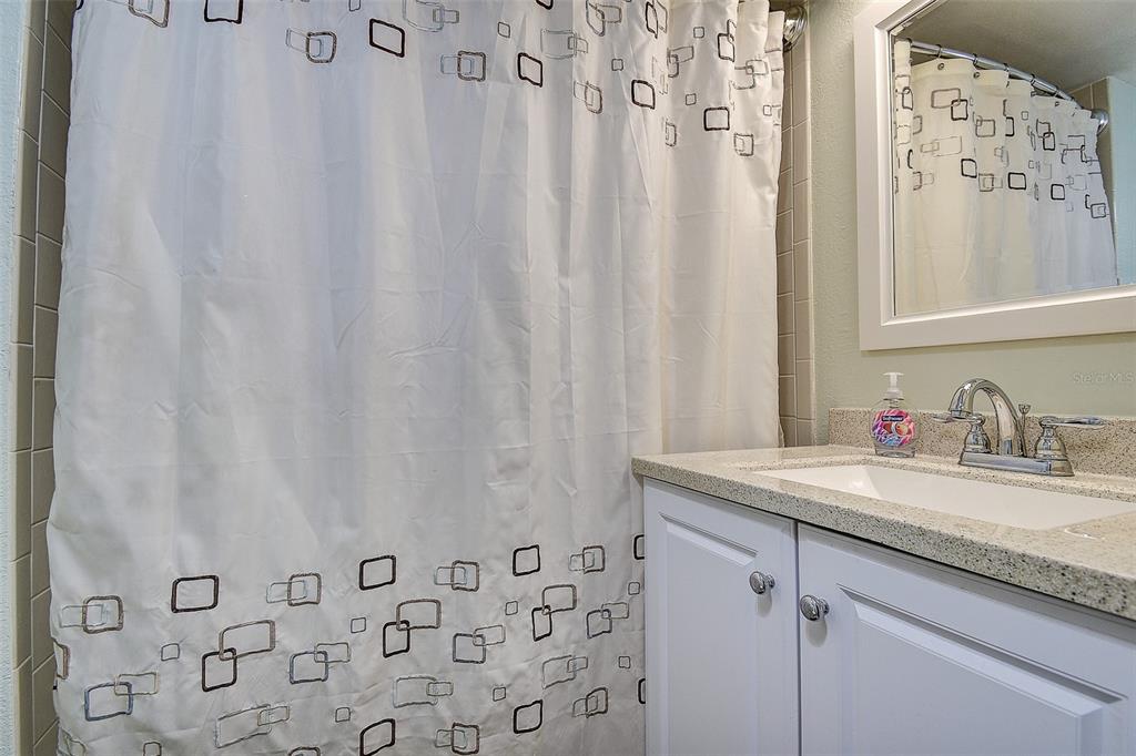 12900 Vonn Road, Unit C202 Largo, FL 33774 - Photo 27 of 38 a bathroom with a granite countertop sink and a mirror