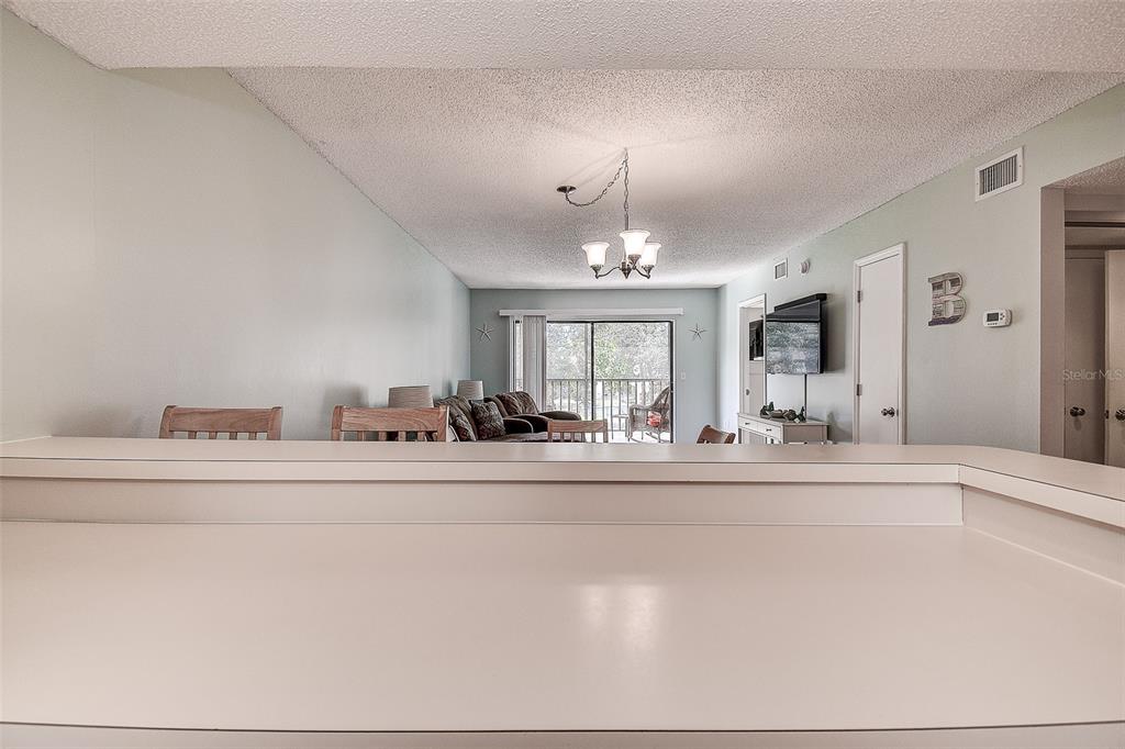 12900 Vonn Road, Unit C202 Largo, FL 33774 - Photo 9 of 38 a living room with furniture and a chandelier