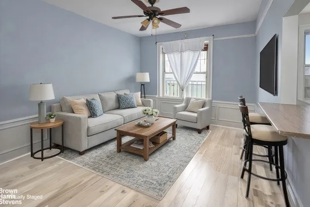 a living room with furniture a rug and a flat screen tv