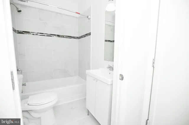 a bathroom with a toilet and a bathtub