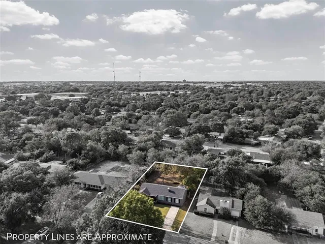 an aerial view of a residential houses with city view