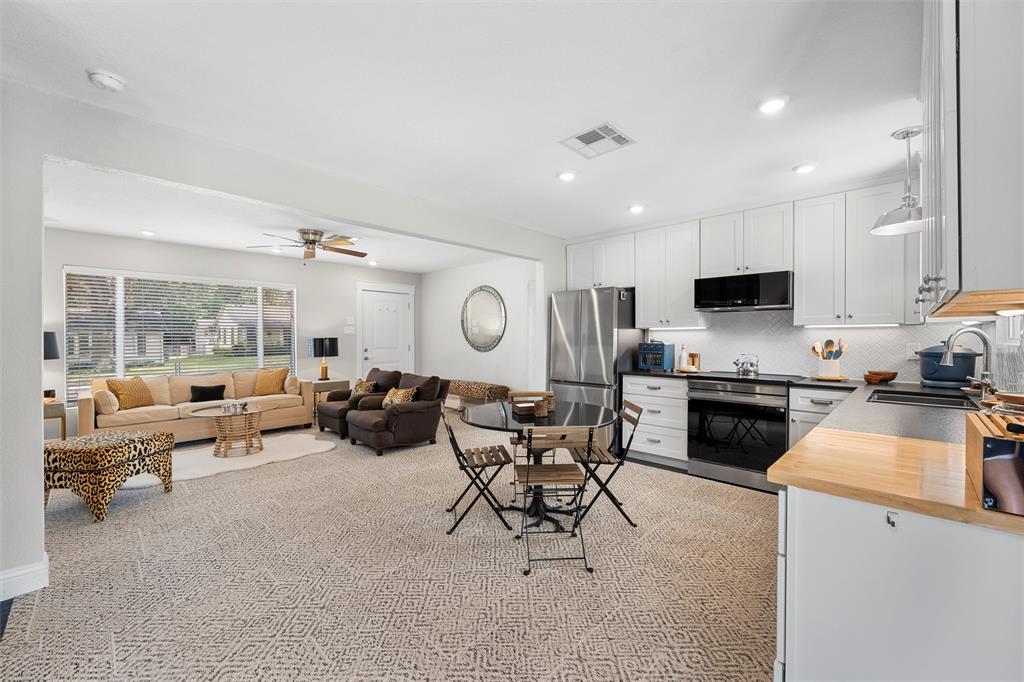 4229 Fort Avenue Waco, TX 76710 - Photo 8 of 40 a living room with furniture and a large window with kitchen view