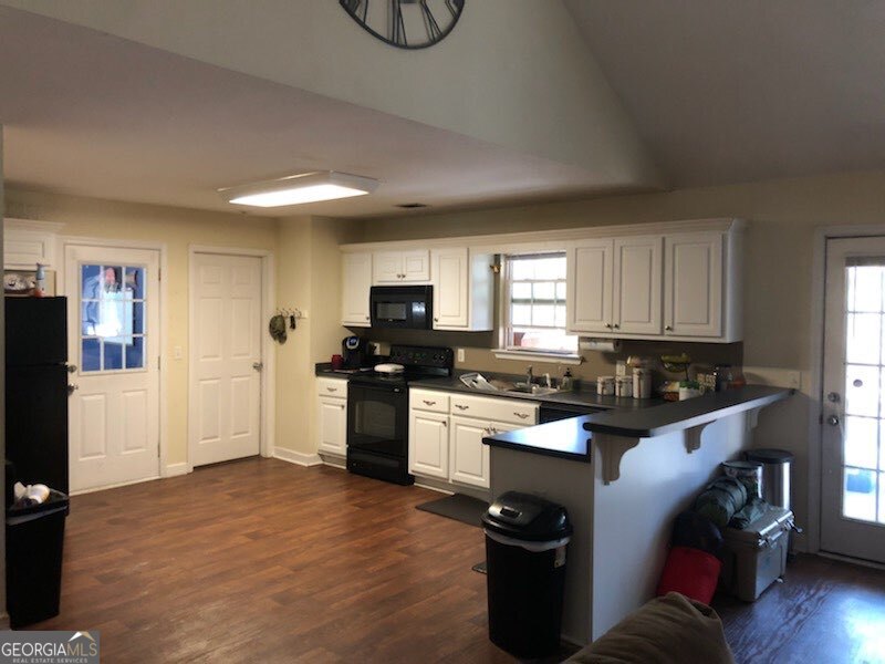 382 Langston Chapel Road Statesboro, GA 30458 - Photo 2 of 7 a kitchen with granite countertop a refrigerator stove top oven and sink