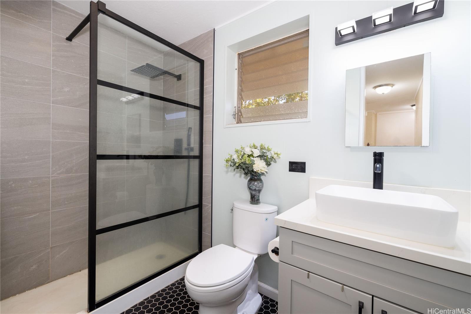 92-739 Makakilo Drive, Unit 21 Kapolei, HI 96707 - Photo 14 of 25 a white toilet sitting next to a bathroom sink