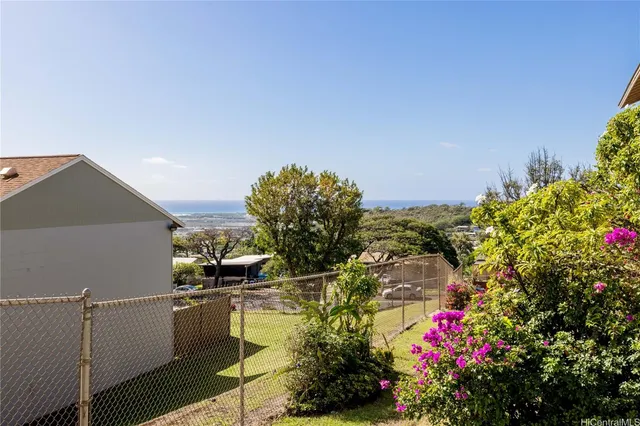 a view of a flower garden with a building
