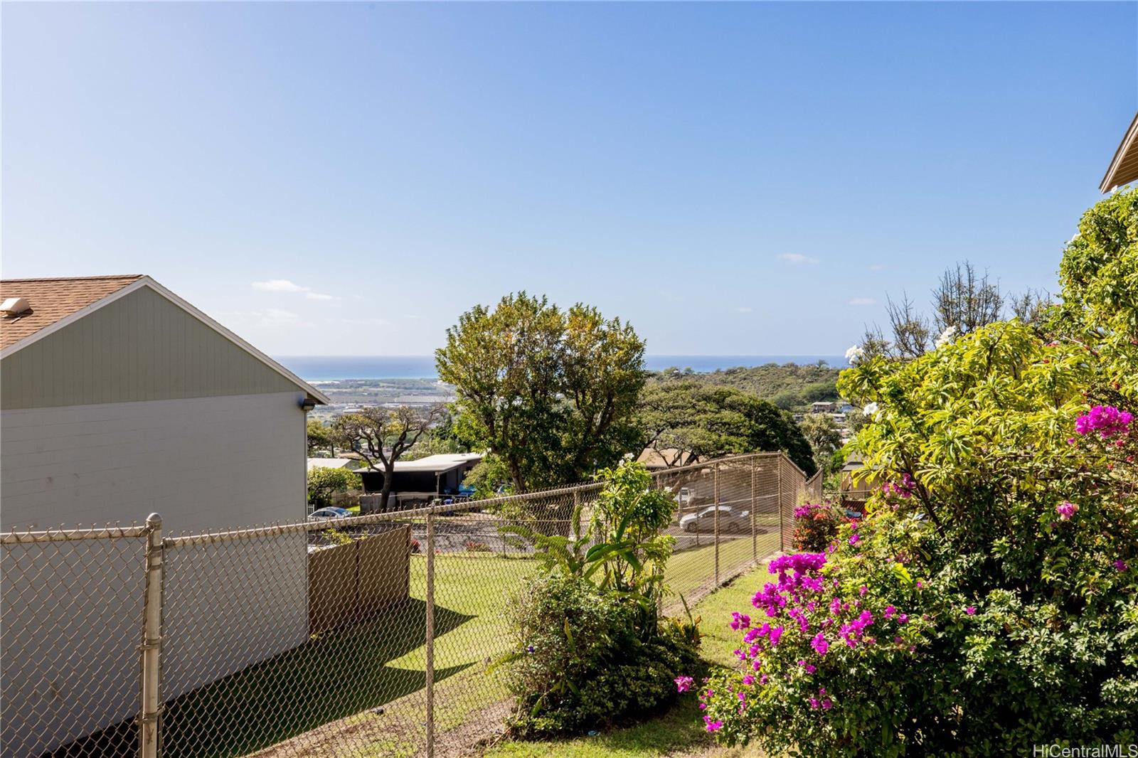 92-739 Makakilo Drive, Unit 21 Kapolei, HI 96707 - Photo 23 of 25 a view of a flower garden with a building