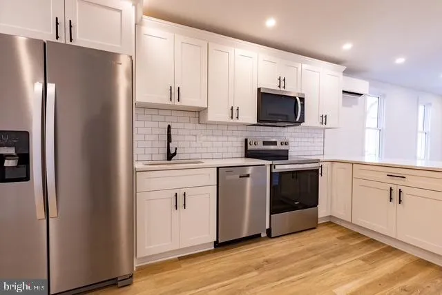 a kitchen with a refrigerator stove and microwave