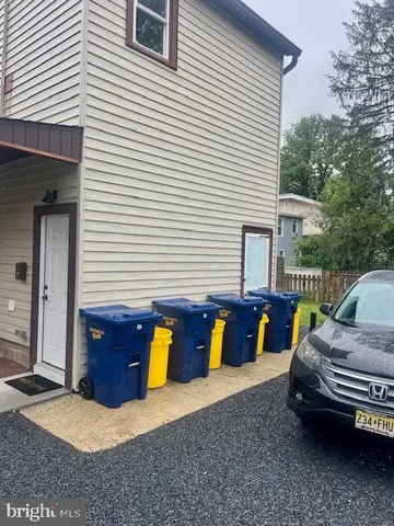 a view of a patio with table and chairs and a barbeque