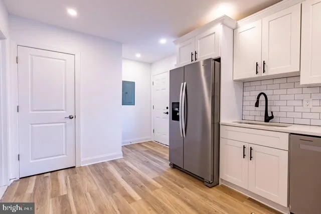 a kitchen with stainless steel appliances a refrigerator and cabinets