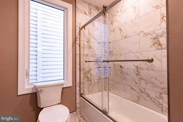 a bathroom with a toilet and a bathtub