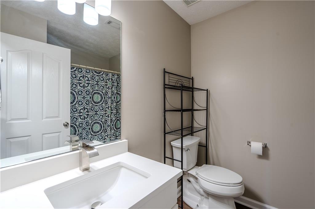 32 Chelsea Lane Grantville, GA 30220 - Photo 12 of 16 a bathroom with a sink toilet vanity and shower