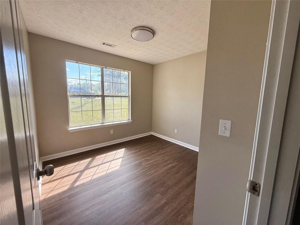 32 Chelsea Lane Grantville, GA 30220 - Photo 13 of 16 a view of an empty room with wooden floor and a window