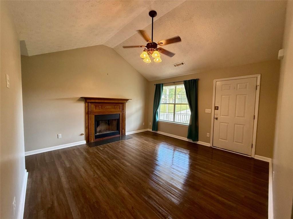 32 Chelsea Lane Grantville, GA 30220 - Photo 3 of 16 a view of an empty room with wooden floor fireplace and a window