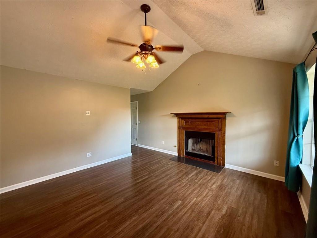 32 Chelsea Lane Grantville, GA 30220 - Photo 4 of 16 a view of an empty room with wooden floor fireplace and a window
