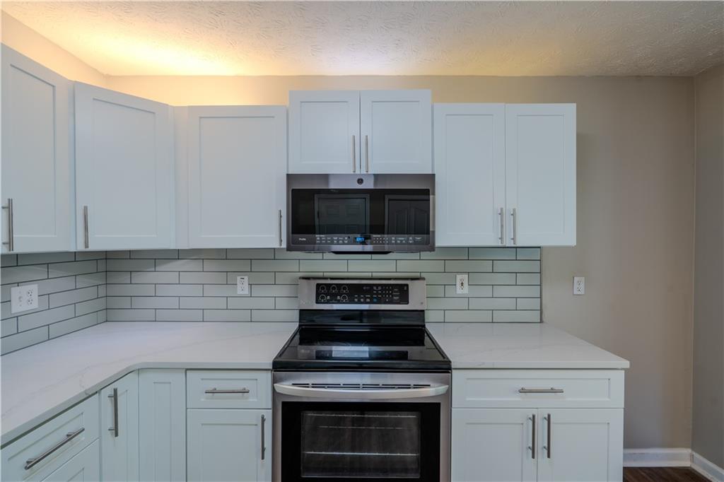 32 Chelsea Lane Grantville, GA 30220 - Photo 6 of 16 a kitchen with cabinets stainless steel appliances and a counter top