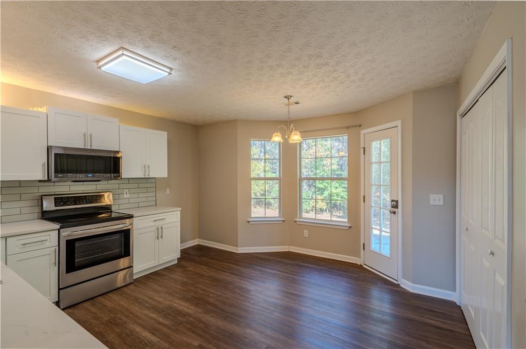 32 Chelsea Lane Grantville, GA 30220 - Photo 7 of 16 a view of a kitchen with a sink dishwasher and a fireplace