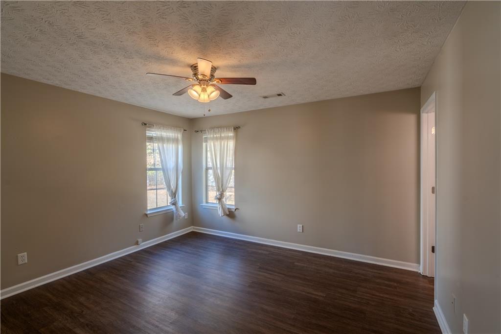 32 Chelsea Lane Grantville, GA 30220 - Photo 8 of 16 a view of empty room with wooden floor and fan