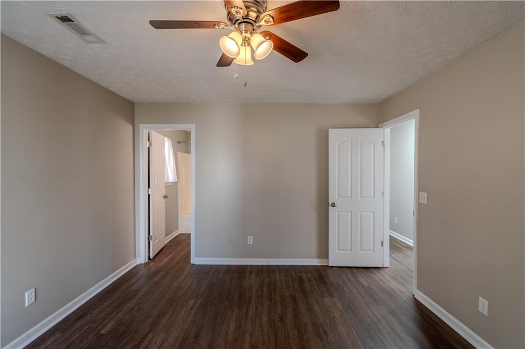 32 Chelsea Lane Grantville, GA 30220 - Photo 9 of 16 an empty room with wooden floor closet and windows