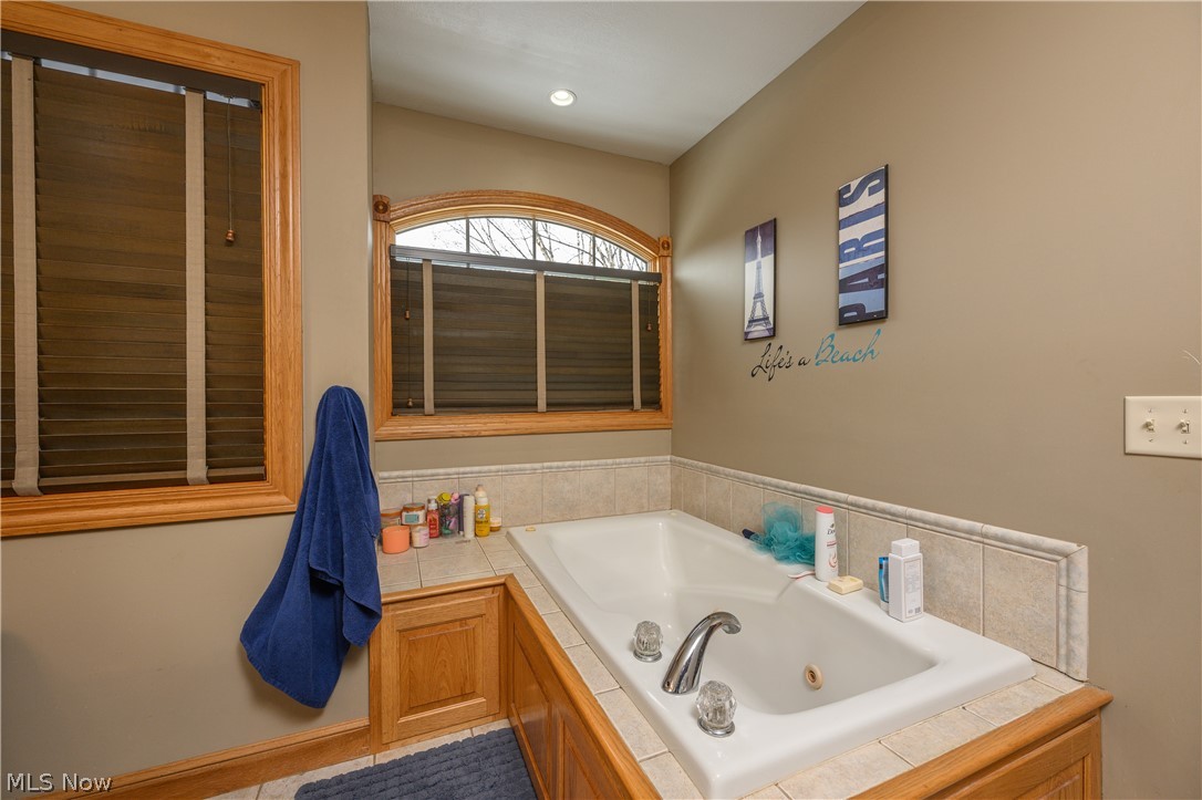 806 Forrest Ridge Drive Dover, OH 44622 - Photo 25 of 36 Full bathroom with a tub with jets and light tile patterned flooring