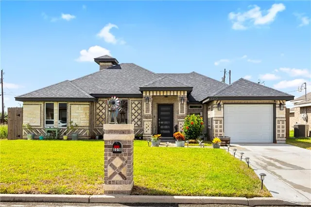 a front view of yellow house with swimming pool