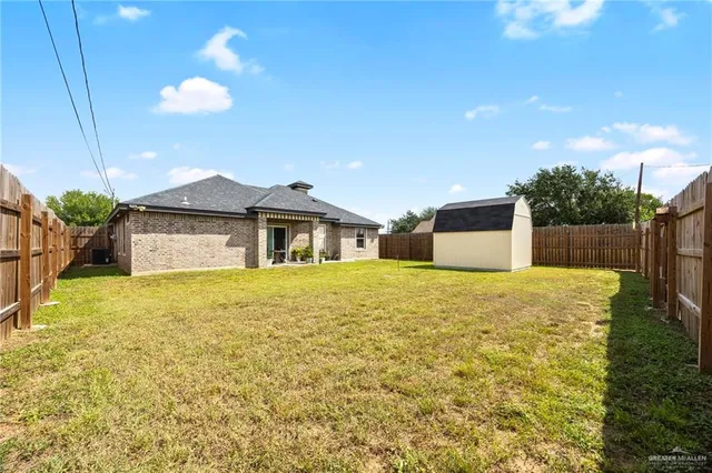 a view of a house with pool and a yard