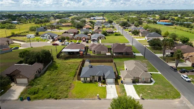 an aerial view of residential houses with outdoor space
