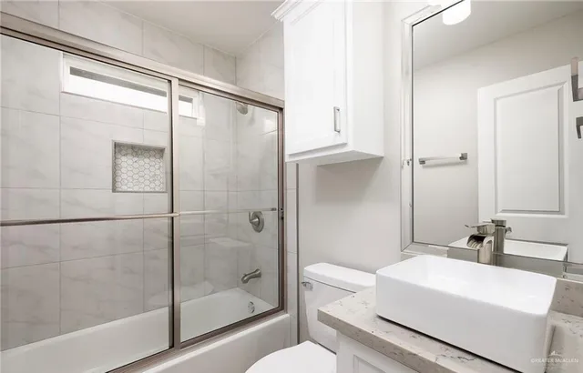 an empty room with a window and a ceiling fan