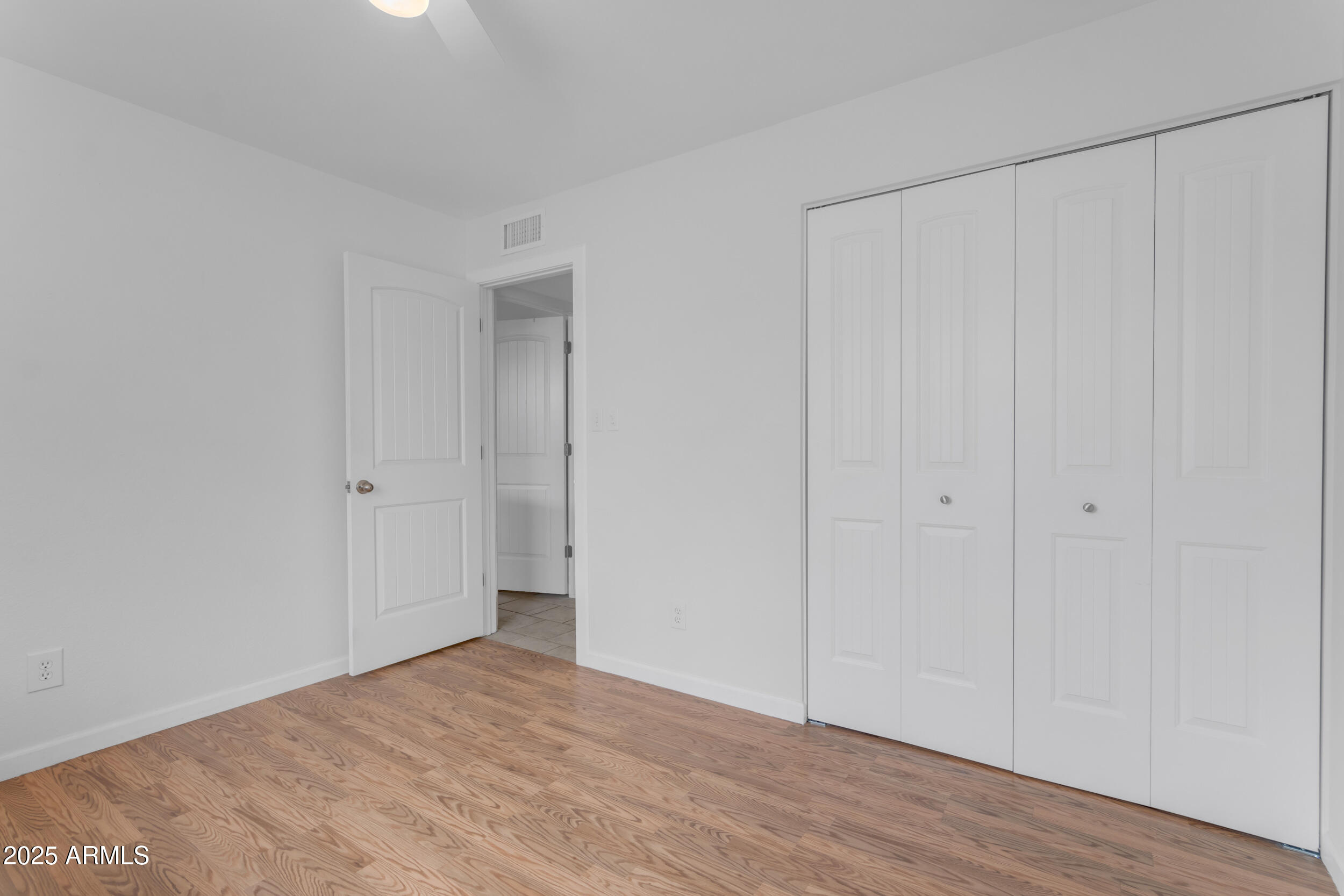 5165 East Tunder Drive Phoenix, AZ 85044 - Photo 22 of 44 a view of empty room with wooden floor