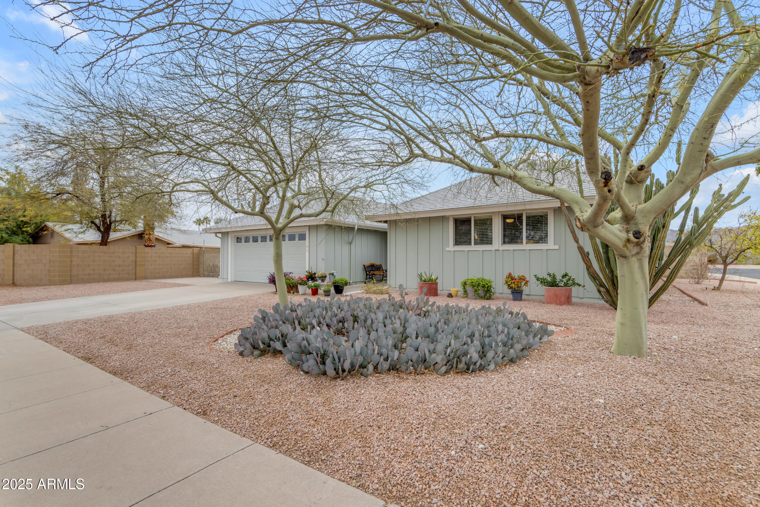 5165 East Tunder Drive Phoenix, AZ 85044 - Photo 3 of 44 a front view of a house with a yard and garage