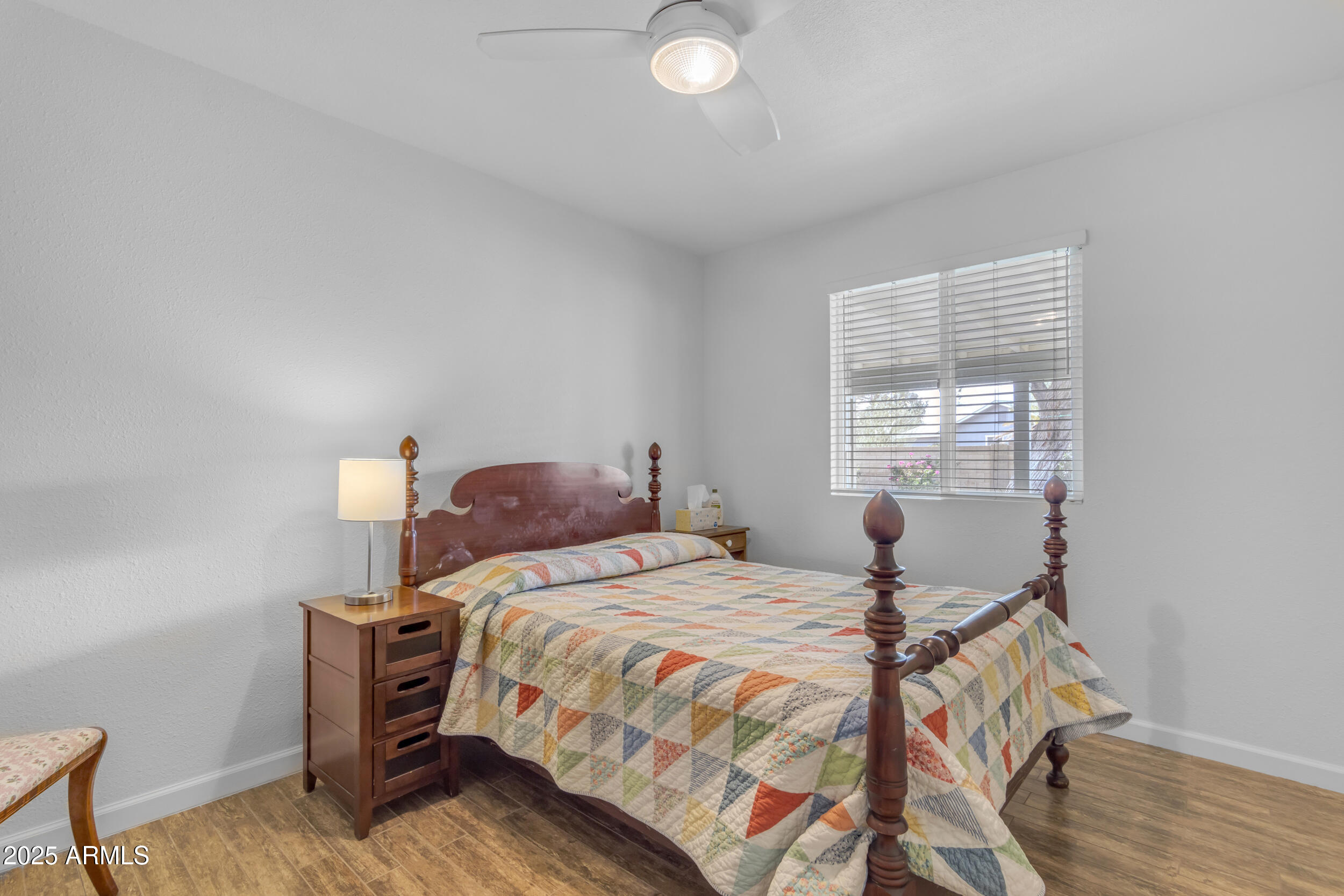 5165 East Tunder Drive Phoenix, AZ 85044 - Photo 33 of 44 a bedroom with a bed and wooden floor