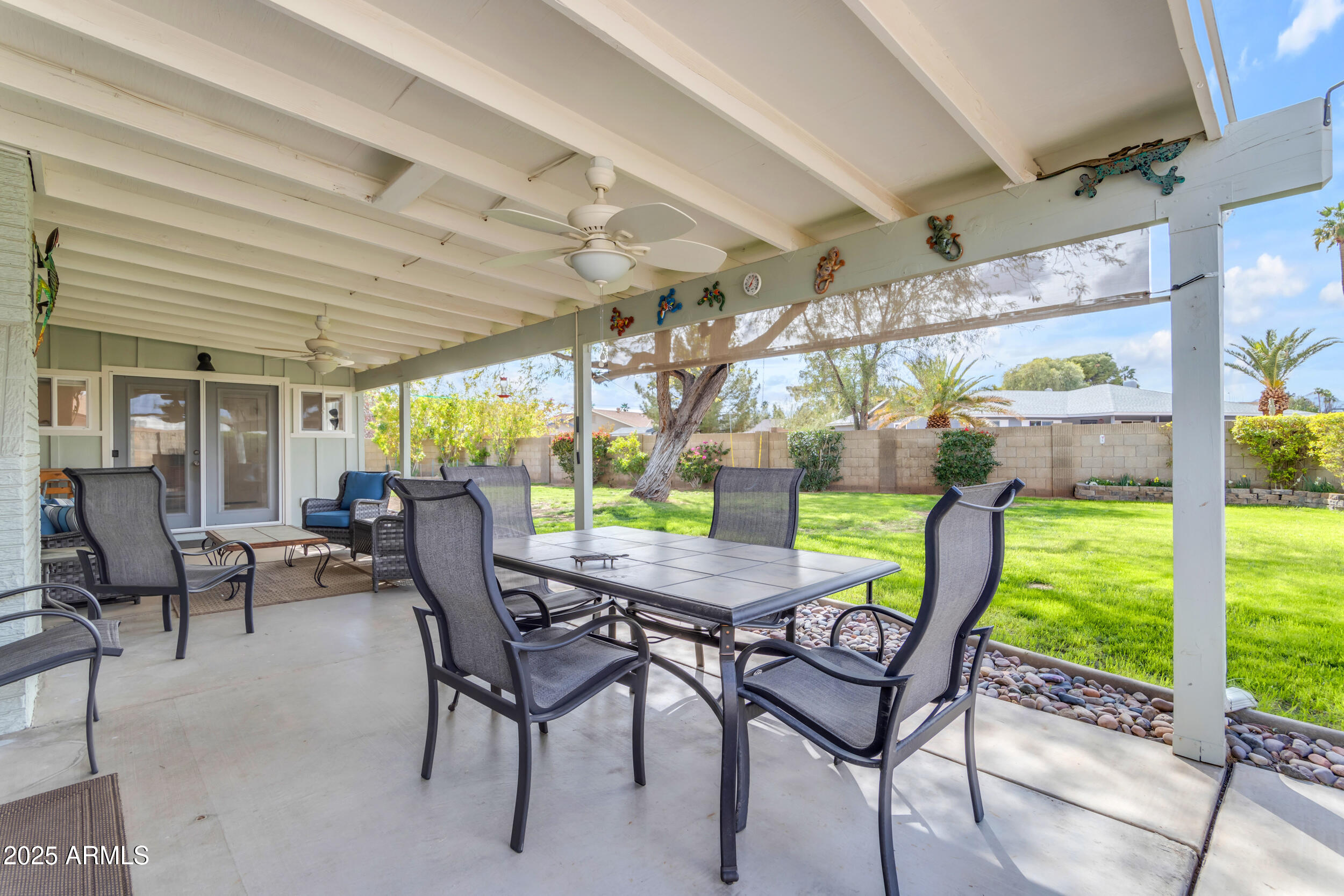 5165 East Tunder Drive Phoenix, AZ 85044 - Photo 38 of 44 a view of a patio with a table chairs and a backyard