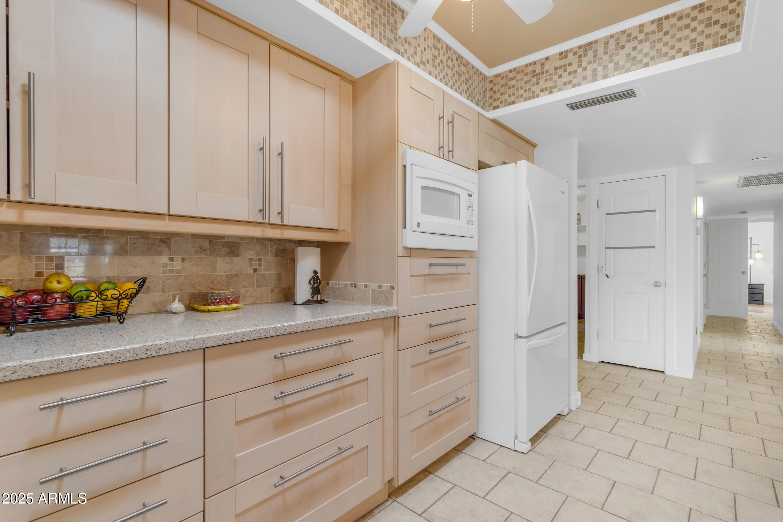 5165 East Tunder Drive Phoenix, AZ 85044 - Photo 8 of 44 a kitchen with granite countertop white cabinets and stainless steel appliances