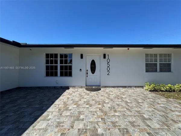a view of a room with a wooden floor and a window