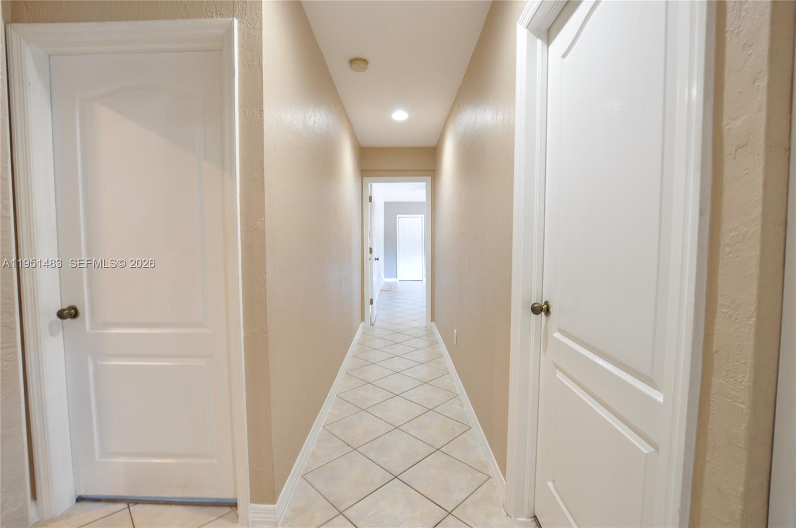 10502 Southwest 77th Court, Unit 10502 Pinecrest, FL 33156 - Photo 11 of 33 a view of a hallway with wooden floor and entryway