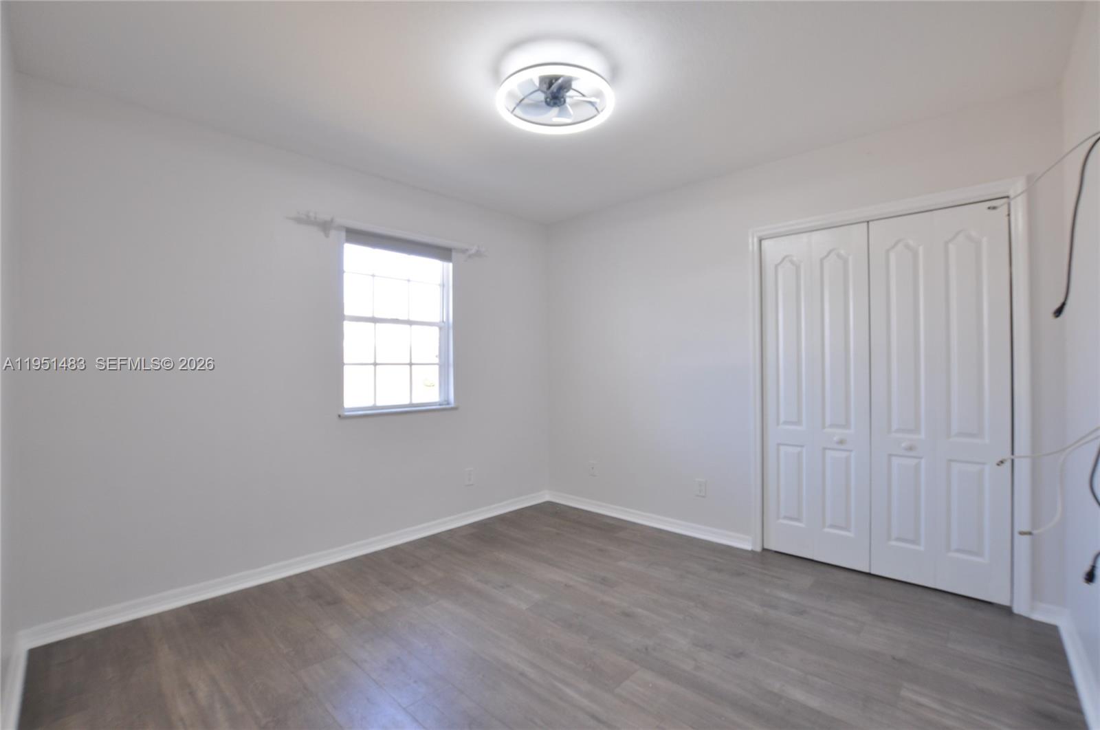 10502 Southwest 77th Court, Unit 10502 Pinecrest, FL 33156 - Photo 12 of 33 an empty room with a window