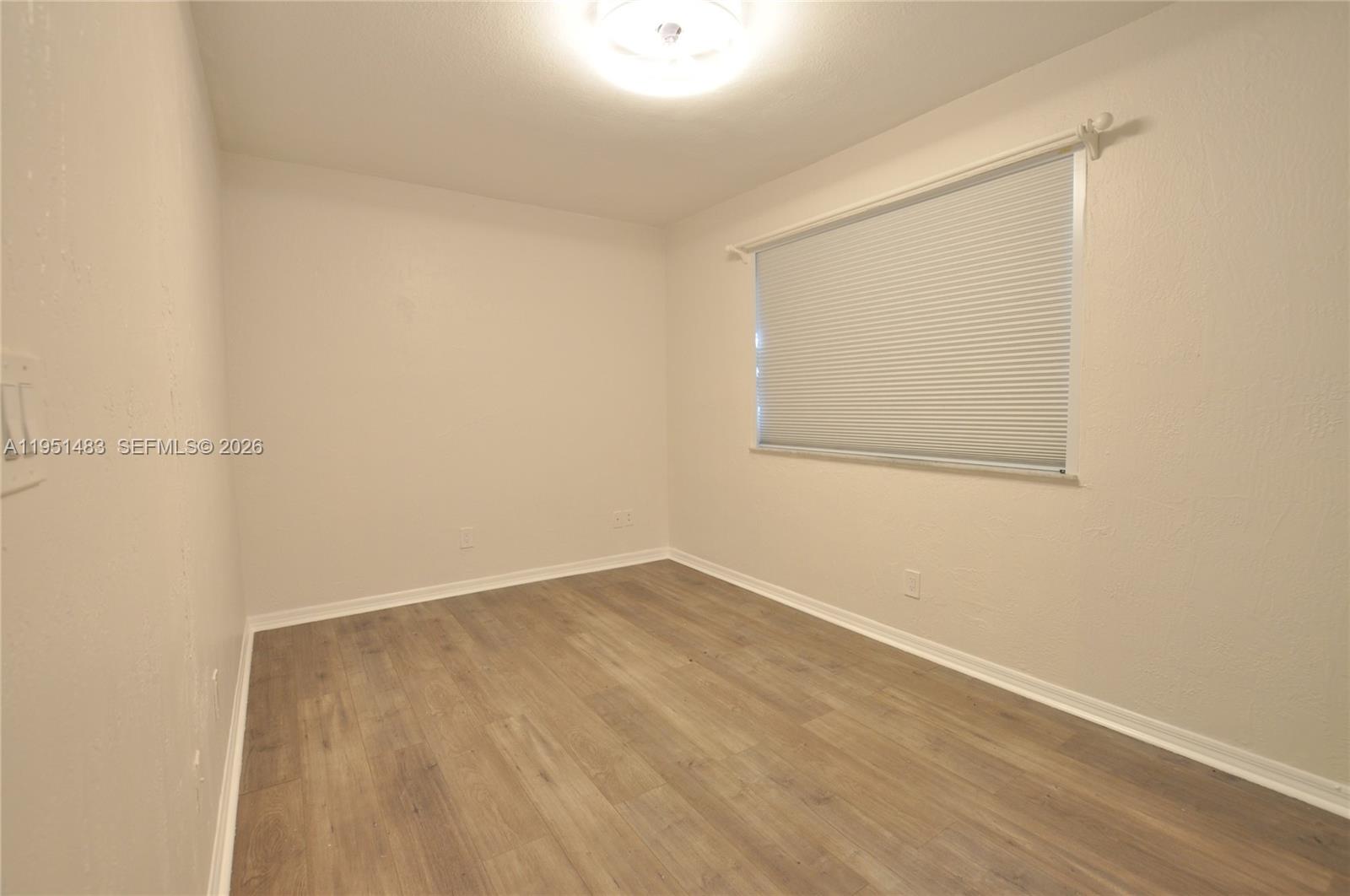 10502 Southwest 77th Court, Unit 10502 Pinecrest, FL 33156 - Photo 14 of 33 an empty room with a window