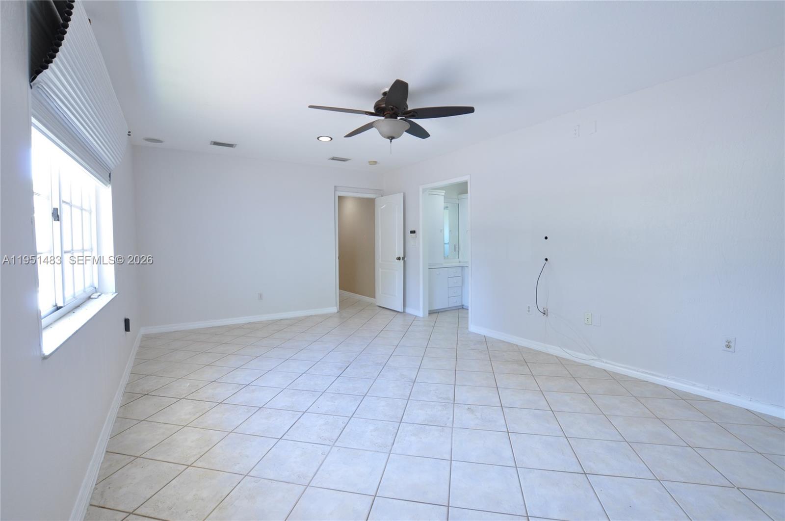 10502 Southwest 77th Court, Unit 10502 Pinecrest, FL 33156 - Photo 16 of 33 a view of an empty room with a window