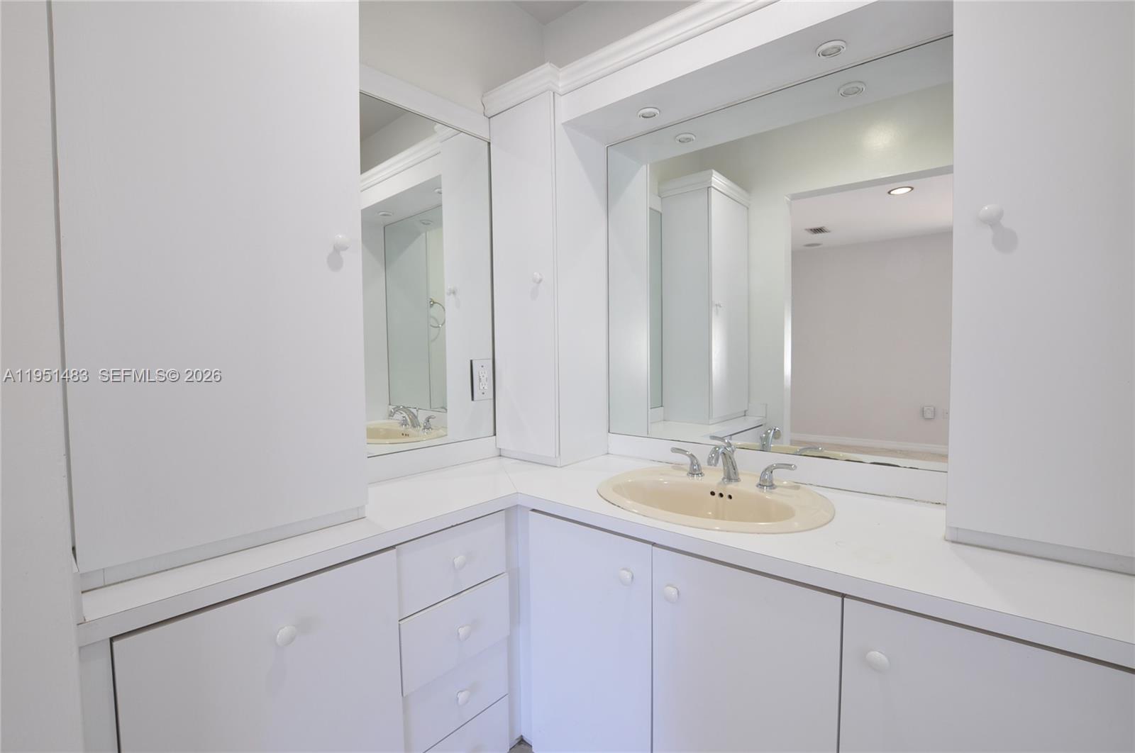 10502 Southwest 77th Court, Unit 10502 Pinecrest, FL 33156 - Photo 19 of 33 a bathroom with a sink and a mirror