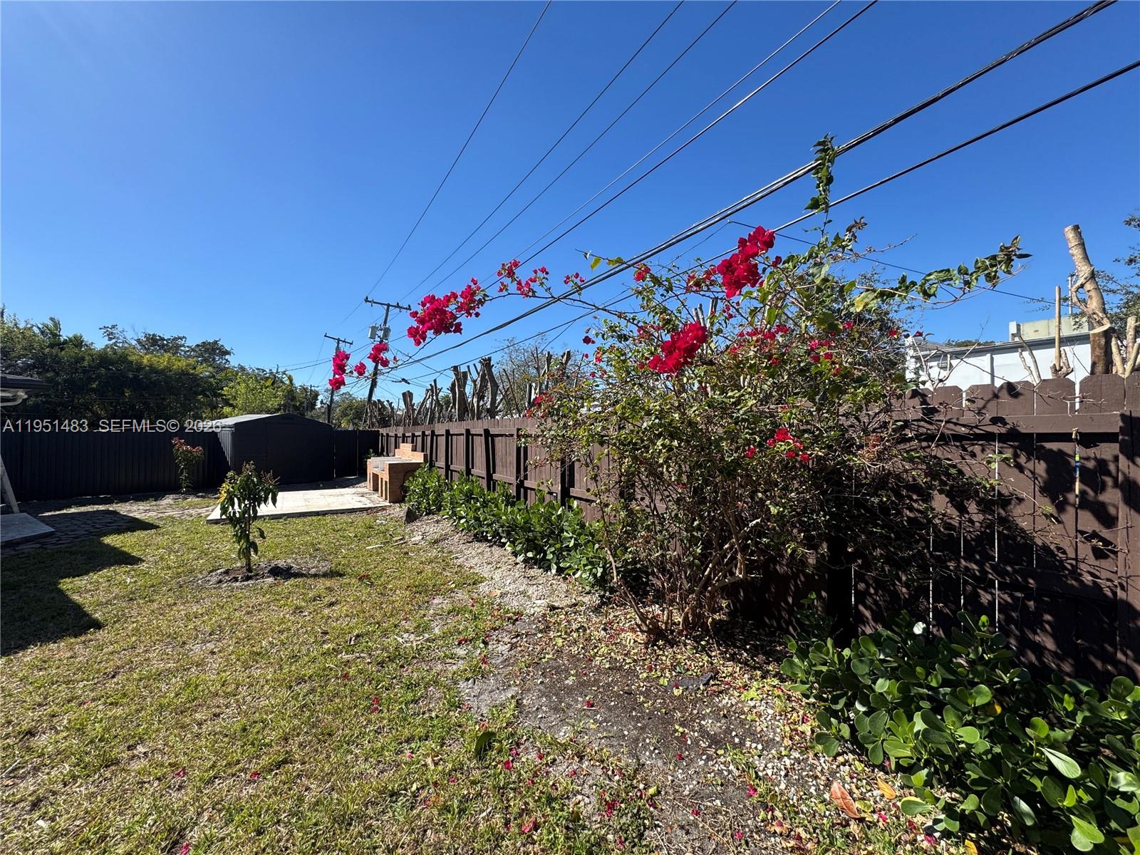 10502 Southwest 77th Court, Unit 10502 Pinecrest, FL 33156 - Photo 28 of 33 a view of a bench in the backyard of a house