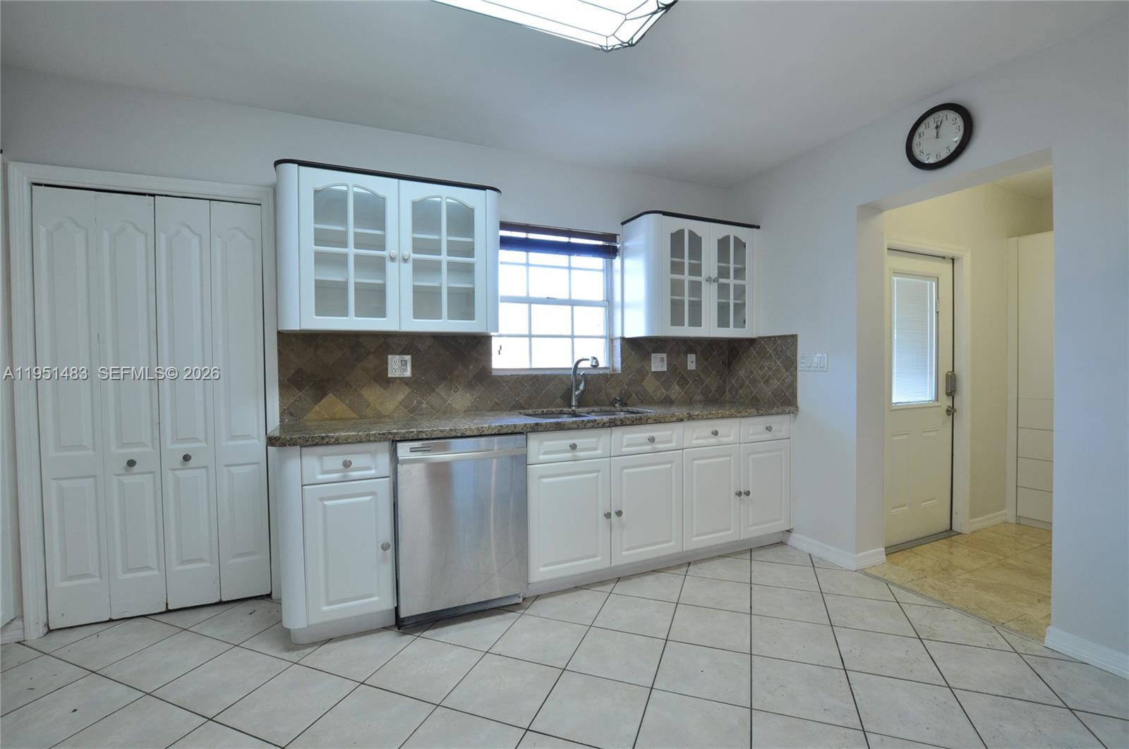 10502 Southwest 77th Court, Unit 10502 Pinecrest, FL 33156 - Photo 7 of 33 a kitchen with granite countertop a sink and a stove