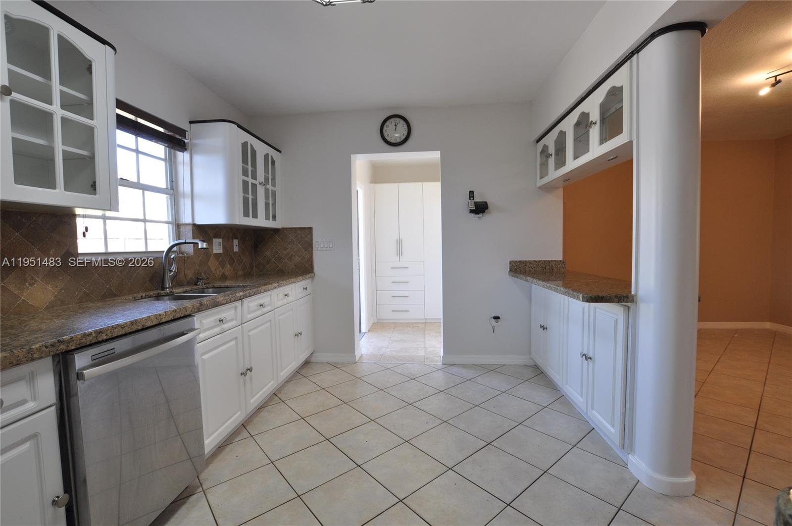 10502 Southwest 77th Court, Unit 10502 Pinecrest, FL 33156 - Photo 9 of 33 a kitchen with white cabinets and sink