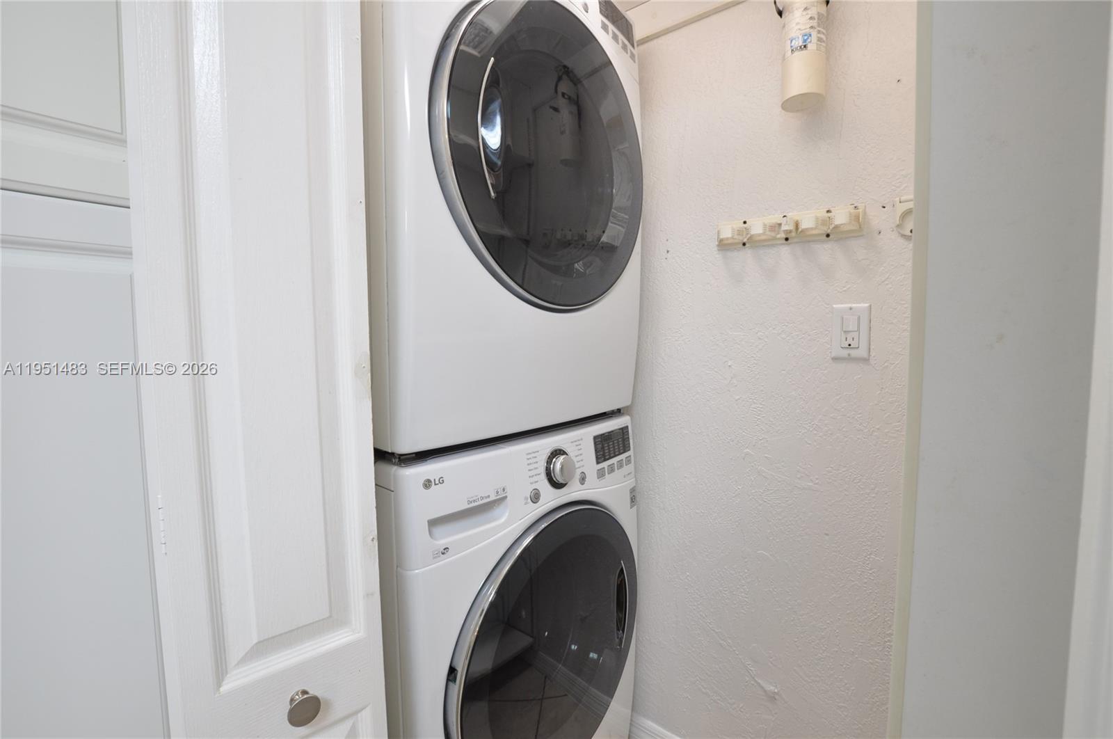 10502 Southwest 77th Court, Unit 10502 Pinecrest, FL 33156 - Photo 10 of 33 a utility room with dryer and washer