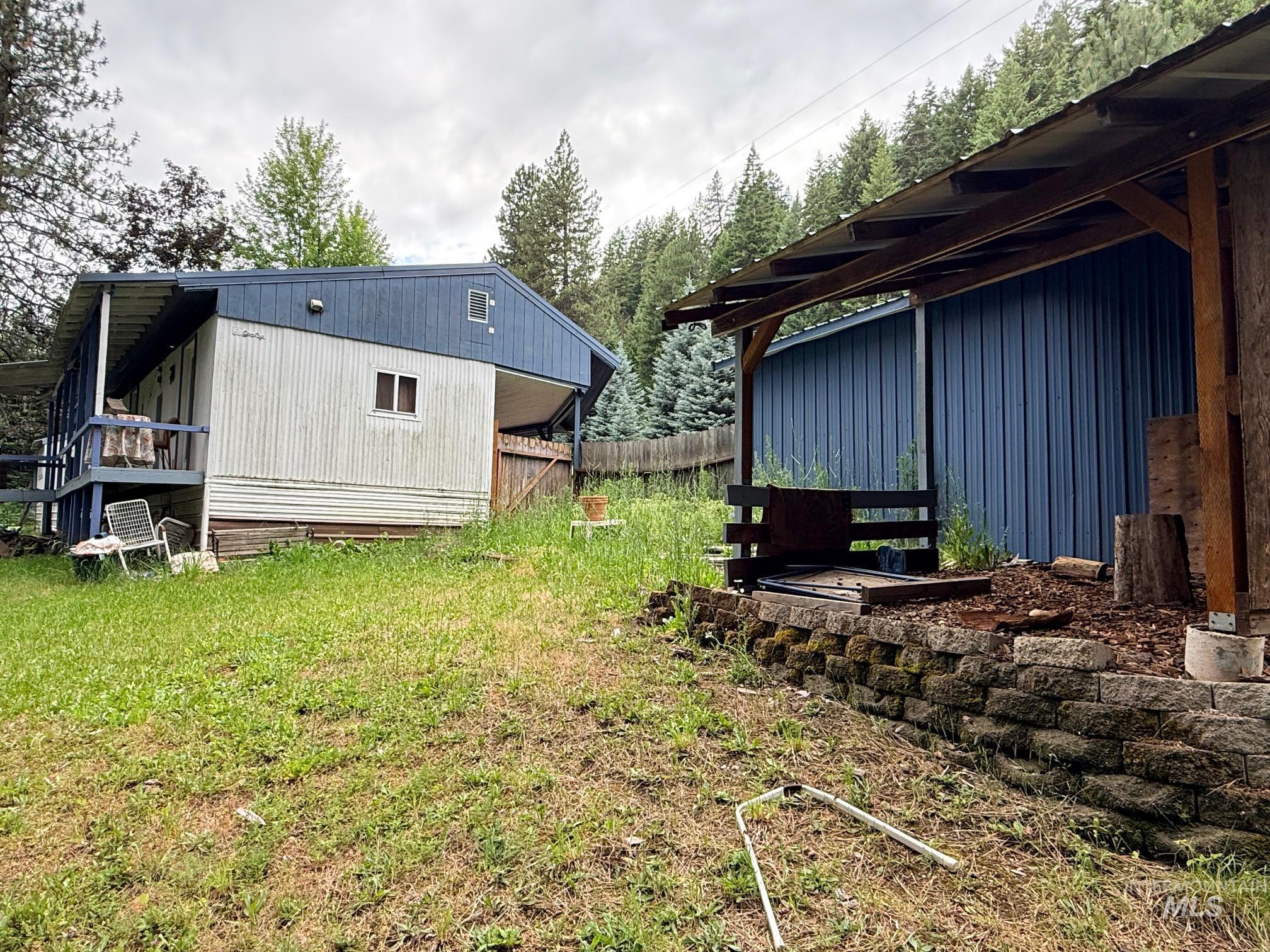 5742 Grangemont Road Orofino, ID 83544 - Photo 18 of 25 Manufactured home featuring a covered front porch and blue exterior accents